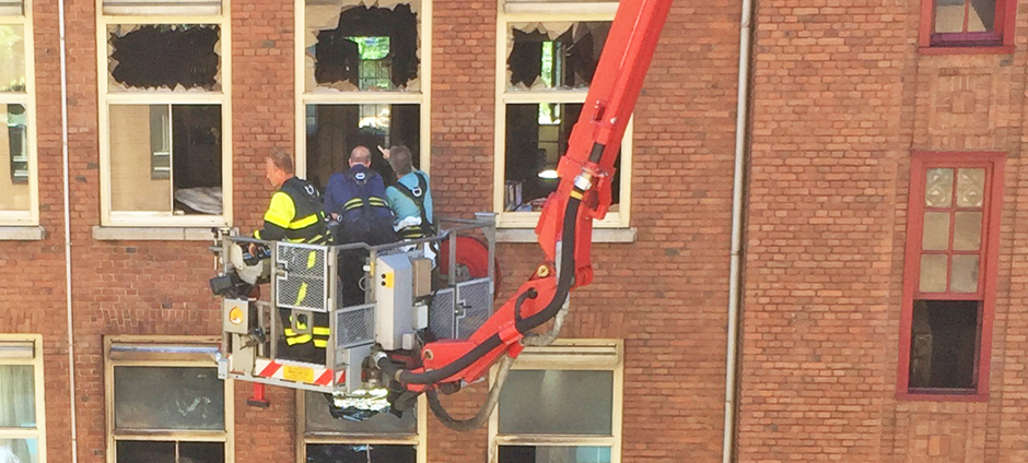 Dutch insurance policies - fire inspectors look at apartment destroyed by blaze in The Hague Netherlands