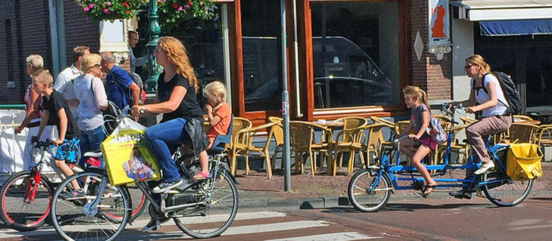 Dutch mothers with young daughters on bicycles in Leiden Netherlands