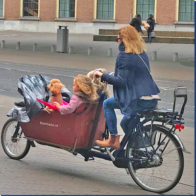 Dutch mother cycling with daughters in Bakfiets Netherlands